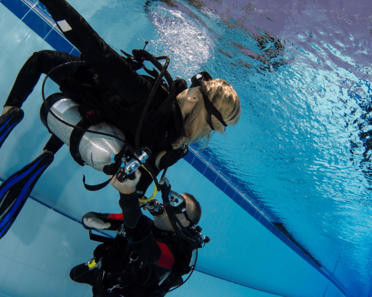 two scuba divers training in pool