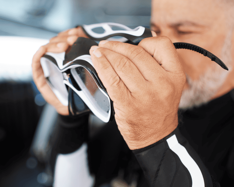 bearded man putting on a scuba mask