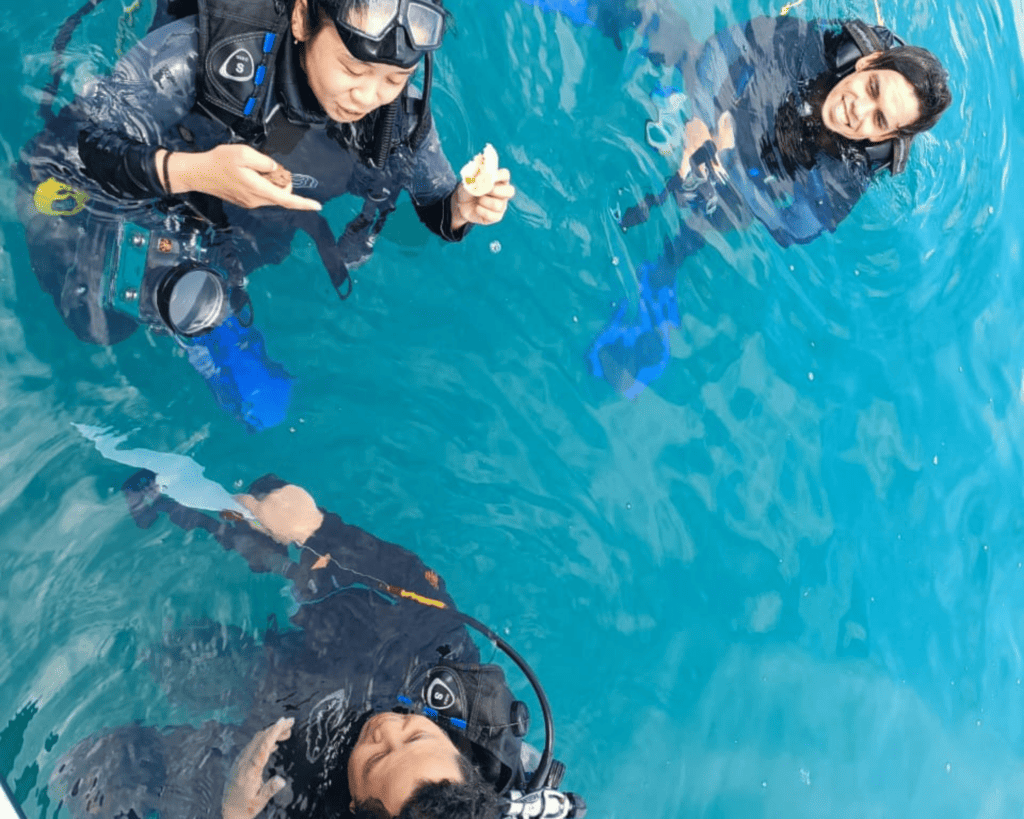 scuba divers eating a snack in the water