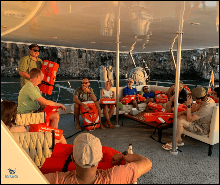 group on a boat with life jackets for safety briefing