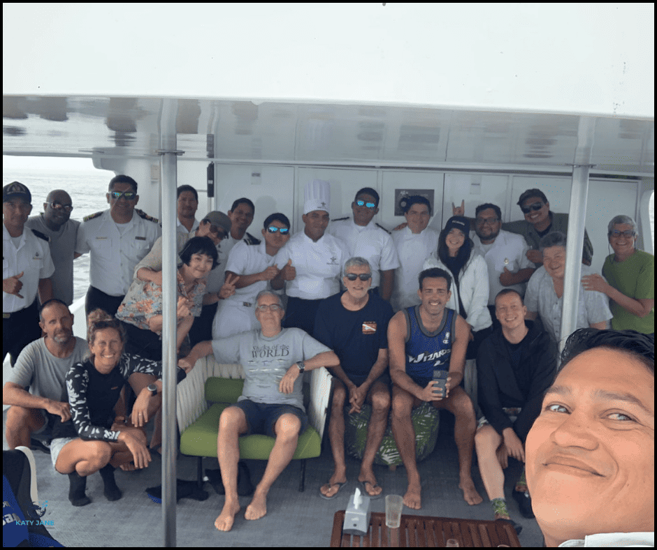 people on board a boat posing for photo