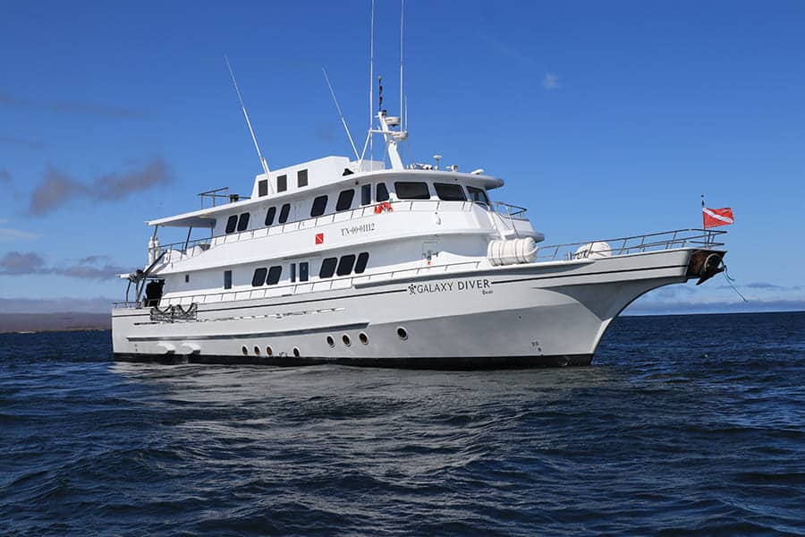 white boat on blue water with blue sky