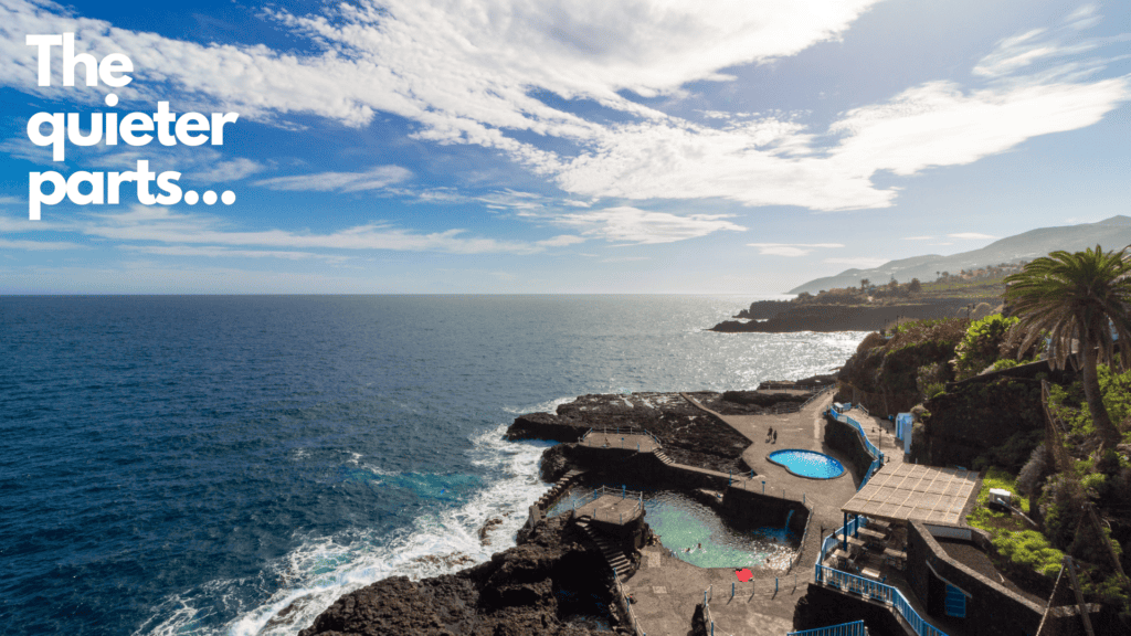 arial photo of rocky coastline with swimming pool and big blue ocean
