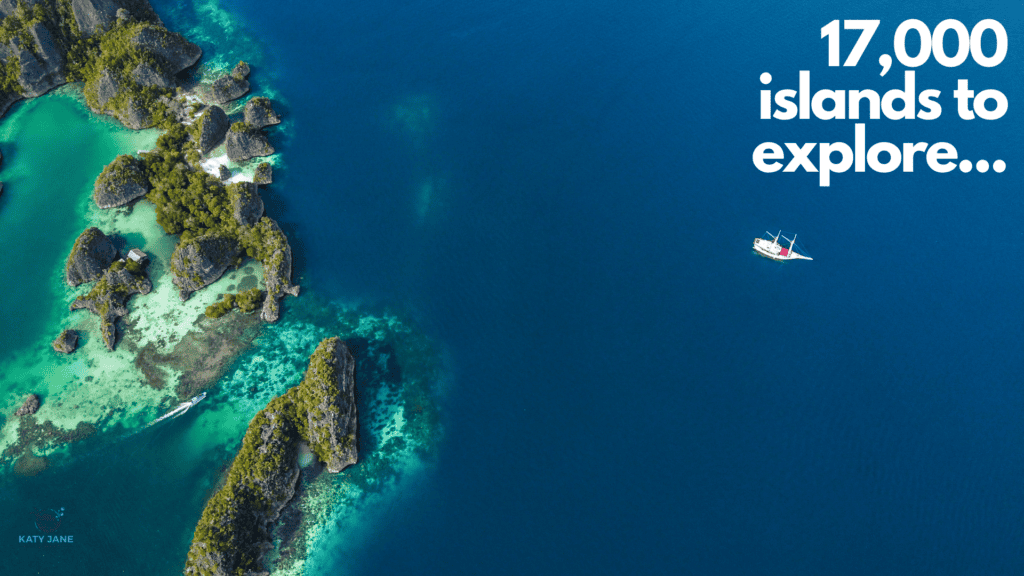 arial photo of islands surrounded by blue green clear waters and one single white boat